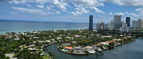 Aerial view of coastal South Florida waterfront homes and high-rises along the ocean